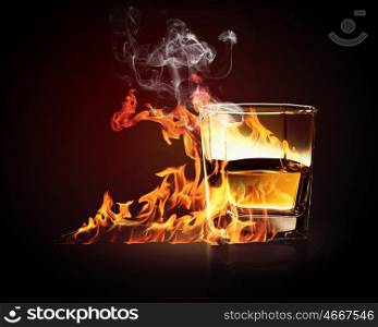 Glass of burning yellow absinthe. Image of glass of burning yellow absinthe