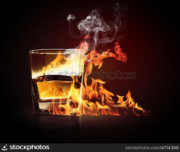 Glass of burning yellow absinthe. Image of glass of burning yellow absinthe