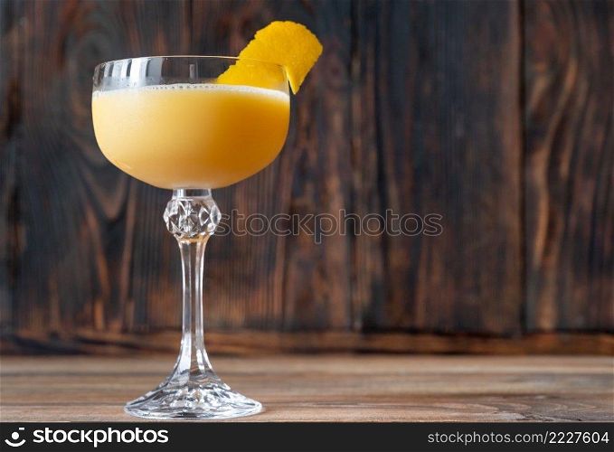 Glass of Canary Flip Cocktail garnished with lemon zest twist