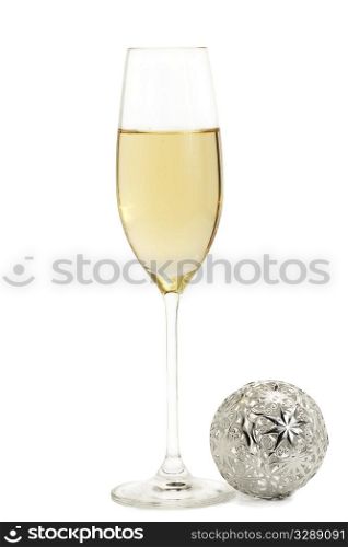 glass of champagne with a metal christmas ball. glass of champagne with a metal christmas ball on white background