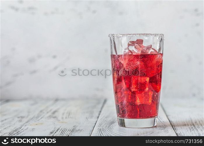 Glass of cherry mojito on the wooden background
