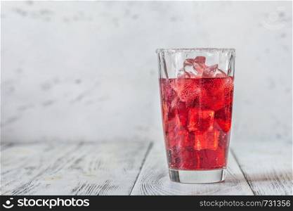 Glass of cherry mojito on the wooden background