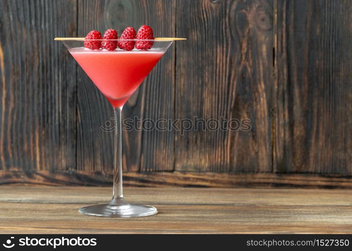 Glass of Clover Club Cocktail on wooden background