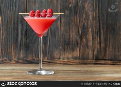 Glass of Clover Club Cocktail on wooden background
