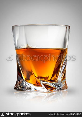 Glass of cognac on a gray background