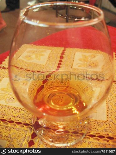 Glass of cognac still on the table in restaurant