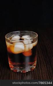 Glass of cola with ice on a table