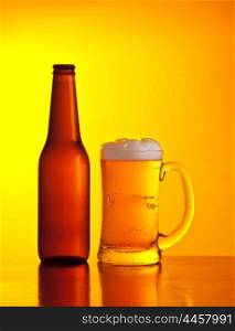 Glass of cold beer drink isolated on yellow warm background, festival of beer