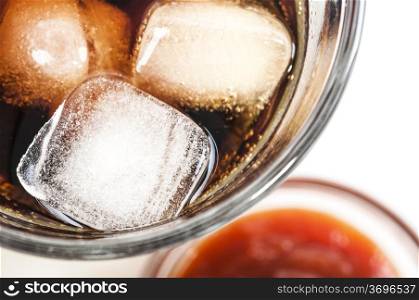 glass of cold coke with ice cubes