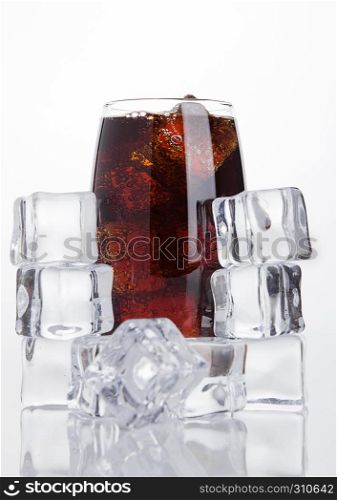 Glass of cold cola soda drink with ice cubes on white background