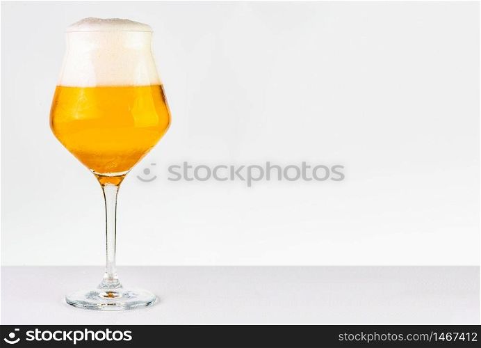 Glass of cold golden beer isolated on a white background. Glass of beer on white background