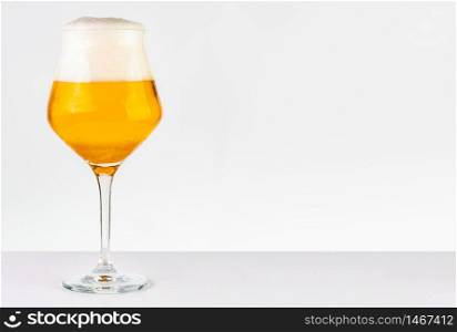 Glass of cold golden beer isolated on a white background. Glass of beer on white background