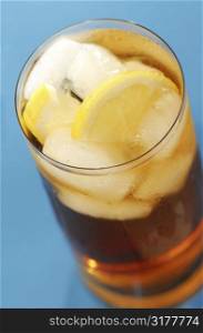Glass of cold lemon iced tea with water drops on surface