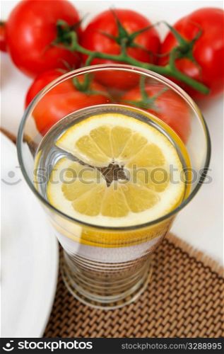 Glass of cold water with a slice of fresh lemon for a refreshing flavor.. Glass Of Lemon Water
