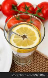 Glass of cold water with a slice of fresh lemon for a refreshing flavor.. Glass Of Lemon Water