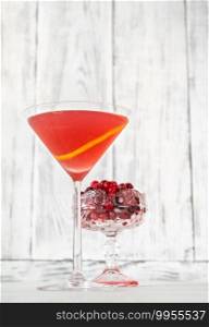 Glass of Cosmopolitan cocktail with fresh cranberries