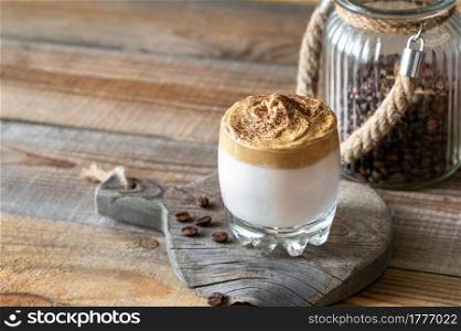 Glass of dalgona coffee on rustic background