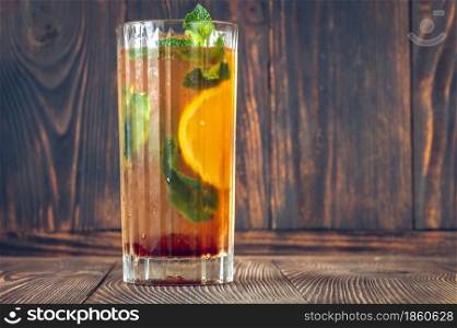 Glass of Dutch Orange Cup cocktail garnished with orange slice and fresh mint leaves