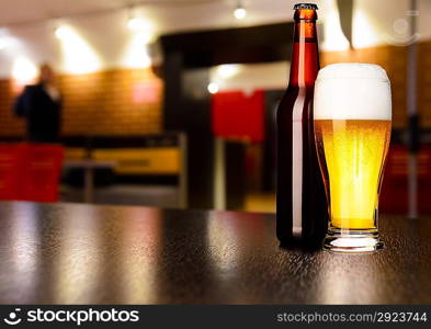 glass of fresh draft lager beer on table in pub