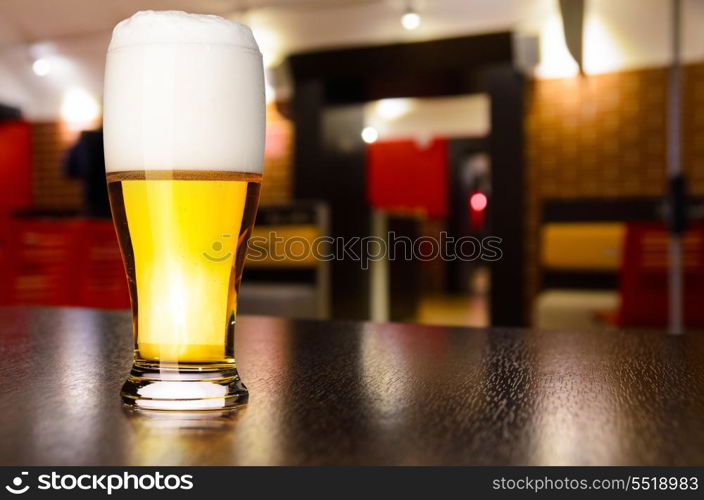 glass of fresh draft lager beer on table in pub. draft beer