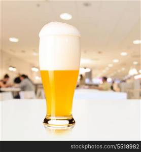 glass of fresh draft unfiltered beer on table in cafe. draft beer