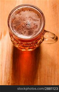 glass of fresh lager beer on wooden table