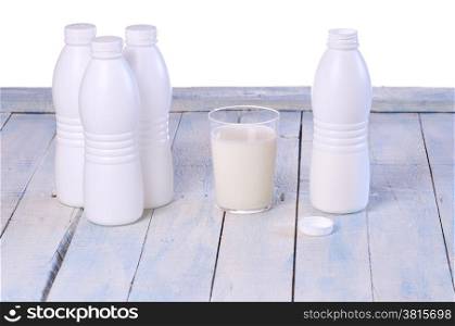 Glass of fresh milk on wooden table in the kitchen.&#xA;