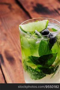 glass of fresh Mojito on wooden