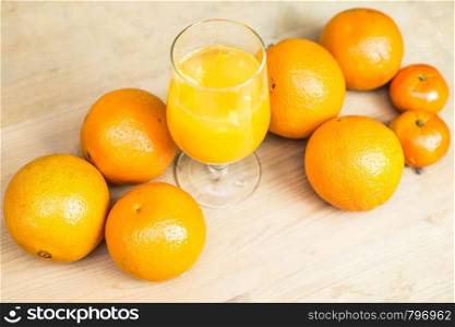 glass of fresh orange juice with fresh fruits on wooden table healthy concept. glass of fresh orange juice with fresh fruits on wooden table