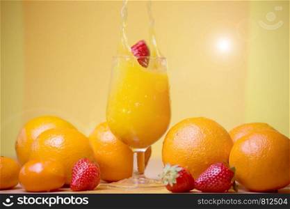 glass of fresh orange juice with fresh fruits on wooden table healthy concept. glass of fresh orange juice with fresh fruits on wooden table
