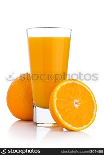 Glass of fresh orange juice with fruit bits on white background