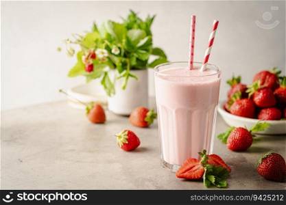 Glass of fresh strawberry milkshake, smoothie and fresh strawberries on light background. Healthy food and drink concept.. Glass of fresh strawberry milkshake