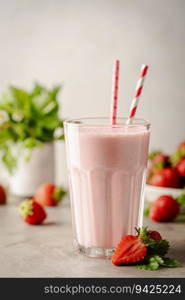 Glass of fresh strawberry milkshake, smoothie and fresh strawberries on light background. Healthy food and drink concept.. Glass of fresh strawberry milkshake