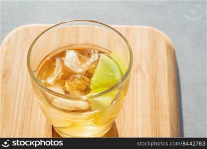 Glass of golden rum on the rocks