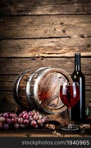 Glass of grape red wine on the table. On a wooden background. . Glass of grape red wine on the table.