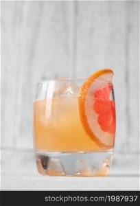Glass of Great Gatsby Cocktail garnished with orange slice wheel