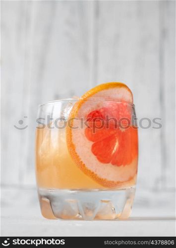 Glass of Great Gatsby Cocktail garnished with orange slice wheel