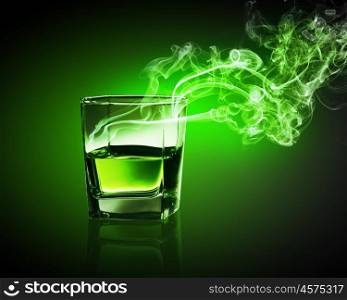 Glass of green absinth. Glass of green absinth with fume going out