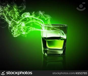 Glass of green absinth. Glass of green absinth with fume going out