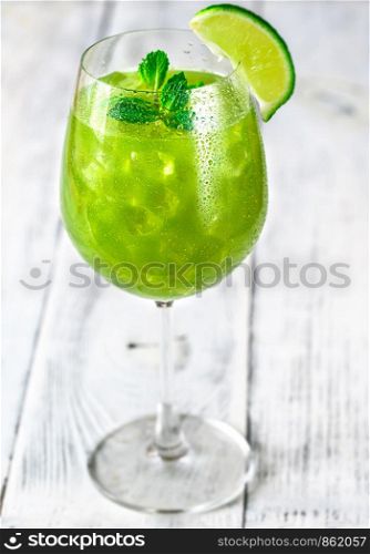 Glass of green mojito with fresh mint and slice of lime
