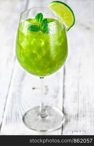 Glass of green mojito with fresh mint and slice of lime