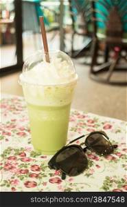 Glass of green tea latte frappe, stock photo