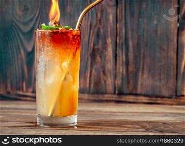 Glass of Holy water cocktail on the wooden background