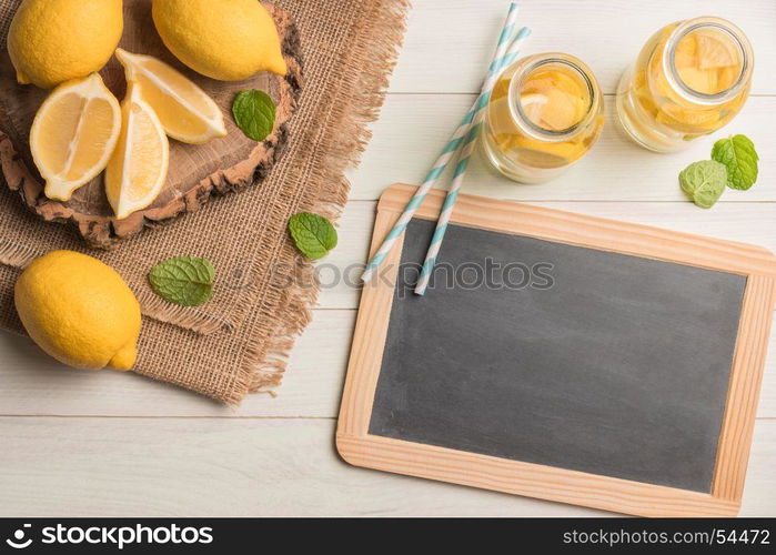 Glass of homemade lemonade with mint and lemon wedges. Top view with copy space.