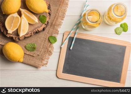Glass of homemade lemonade with mint and lemon wedges. Top view with copy space.