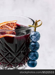 Glass of hot mulled wine with spices