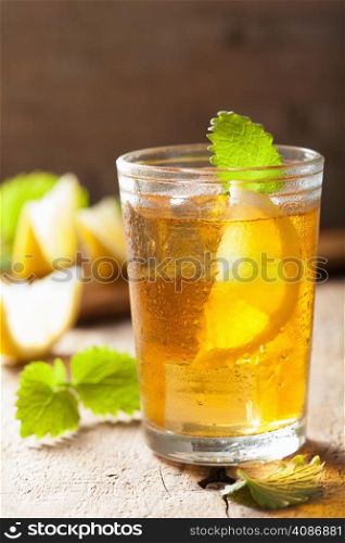 glass of ice tea with lemon and melissa