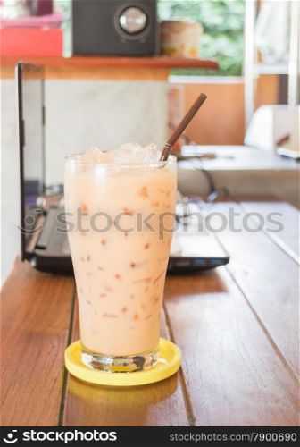 Glass of iced thai milk tea, stock photo