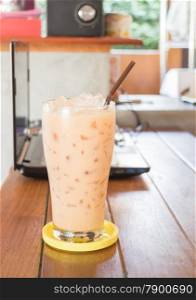 Glass of iced thai milk tea, stock photo