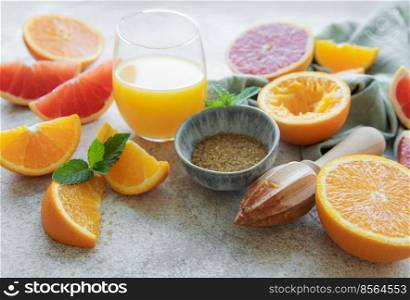 Glass of juice and fresh citrus fruits 